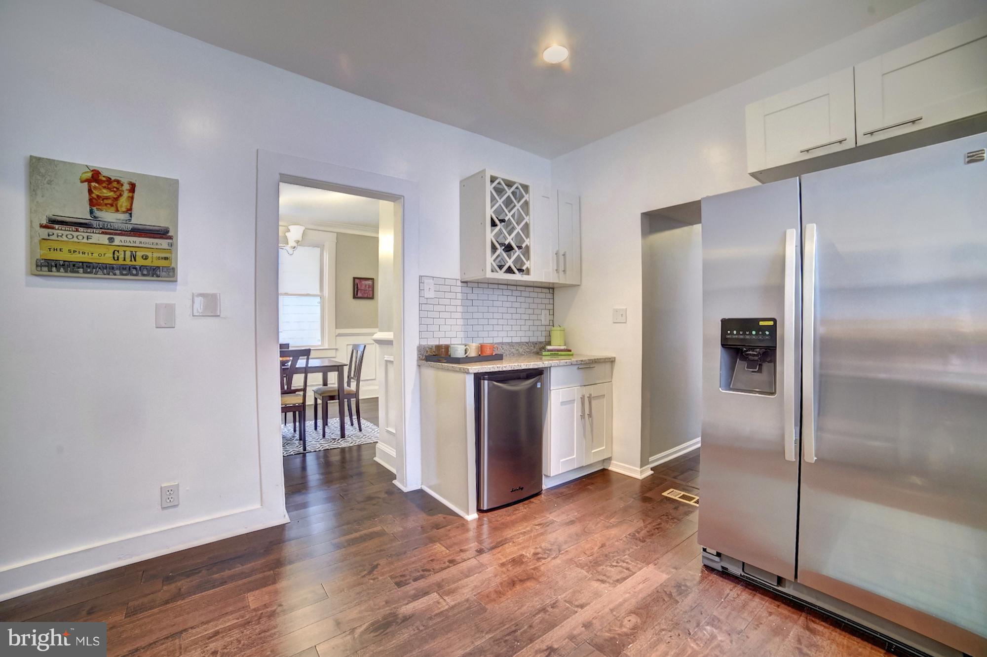 4008 Ridgecroft Road Baltimore, MD 21206 - Photo 7 of 17 a kitchen with a refrigerator and a stove top oven