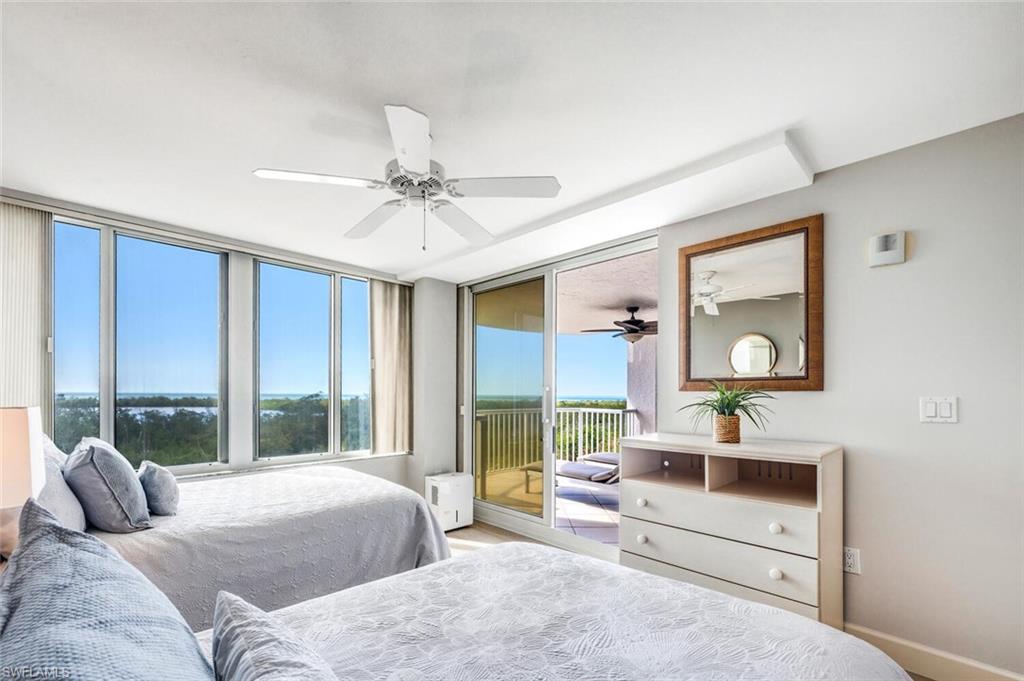 6849 Grenadier Boulevard, Unit 503 Naples, FL 34108 - Photo 24 of 50 a bedroom with a large bed and a large window