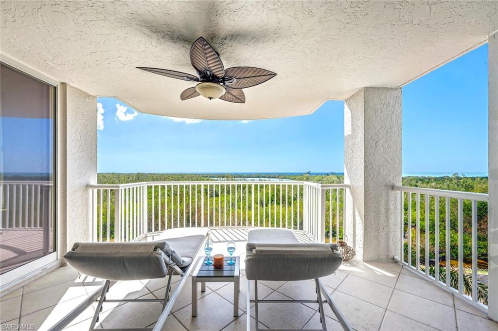 6849 Grenadier Boulevard, Unit 503 Naples, FL 34108 - Photo 30 of 50 a living room with furniture and a floor to ceiling window