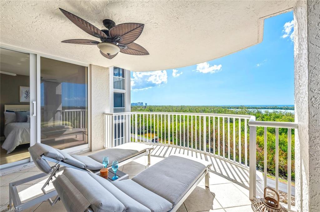 6849 Grenadier Boulevard, Unit 503 Naples, FL 34108 - Photo 32 of 50 a roof deck with table and chairs