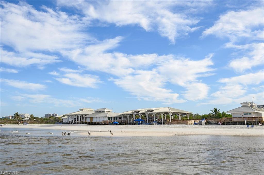 6849 Grenadier Boulevard, Unit 503 Naples, FL 34108 - Photo 43 of 50 a view of an ocean beach and mountain