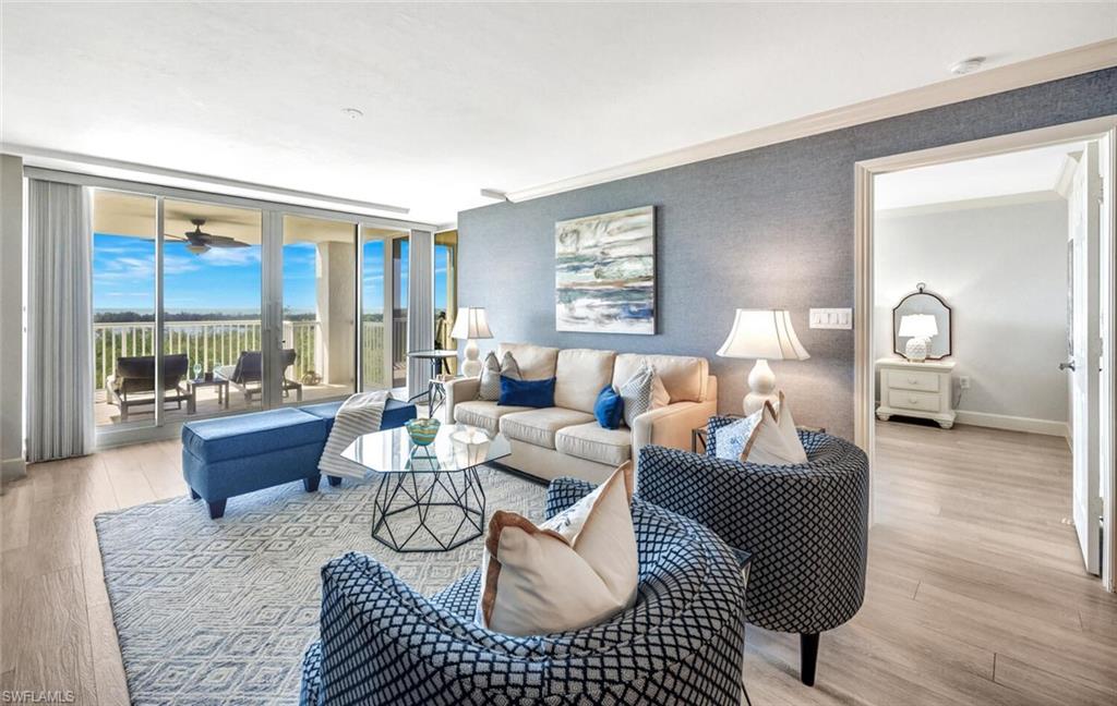 6849 Grenadier Boulevard, Unit 503 Naples, FL 34108 - Photo 6 of 50 a living room with furniture or couch and a large window