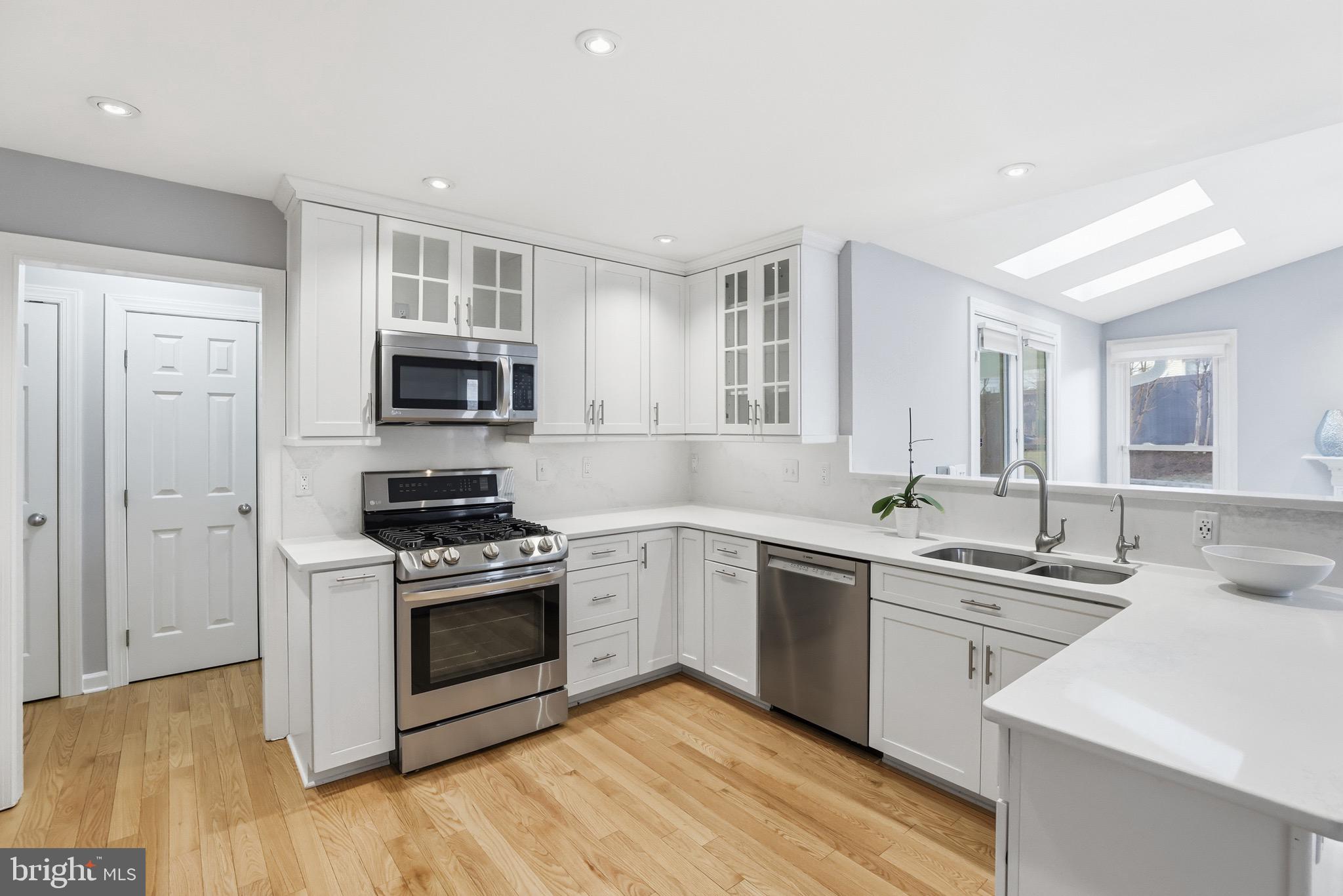 13222 Maplecrest Drive Potomac, MD 20854 - Photo 14 of 61 a kitchen with sink a microwave and cabinets