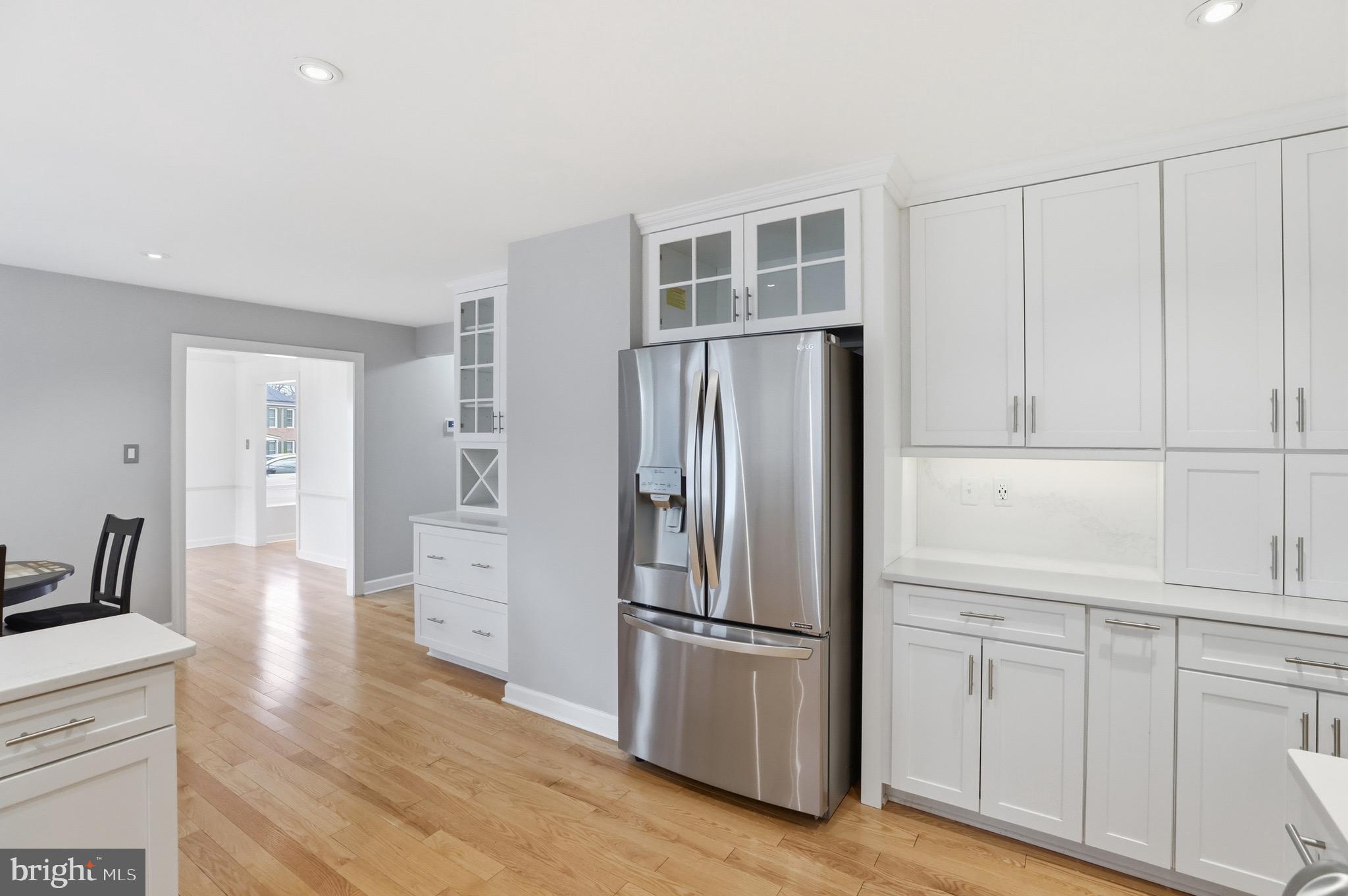13222 Maplecrest Drive Potomac, MD 20854 - Photo 15 of 61 a kitchen with white cabinets and stainless steel appliances