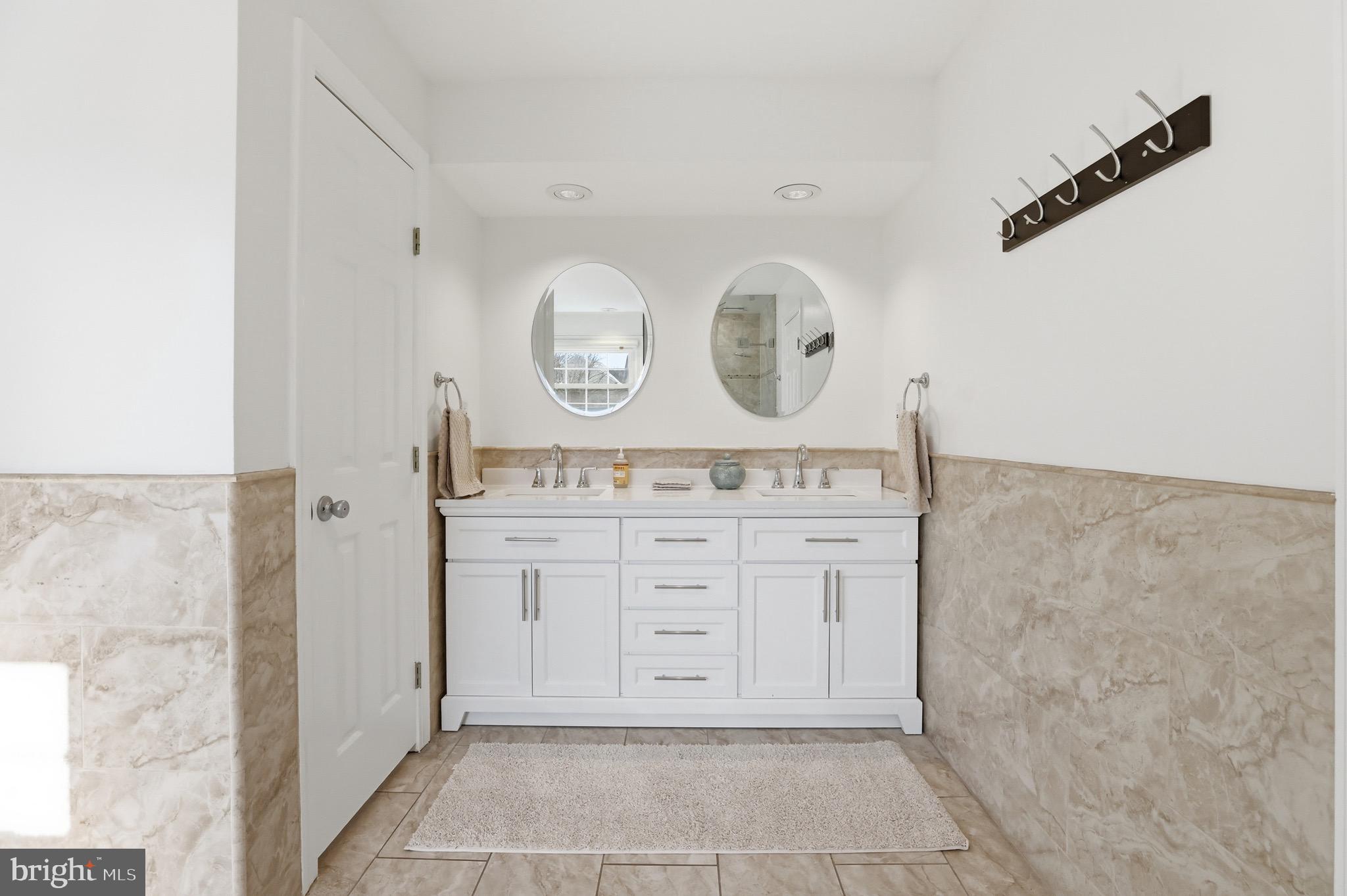13222 Maplecrest Drive Potomac, MD 20854 - Photo 32 of 61 a bathroom with a sink and a mirror