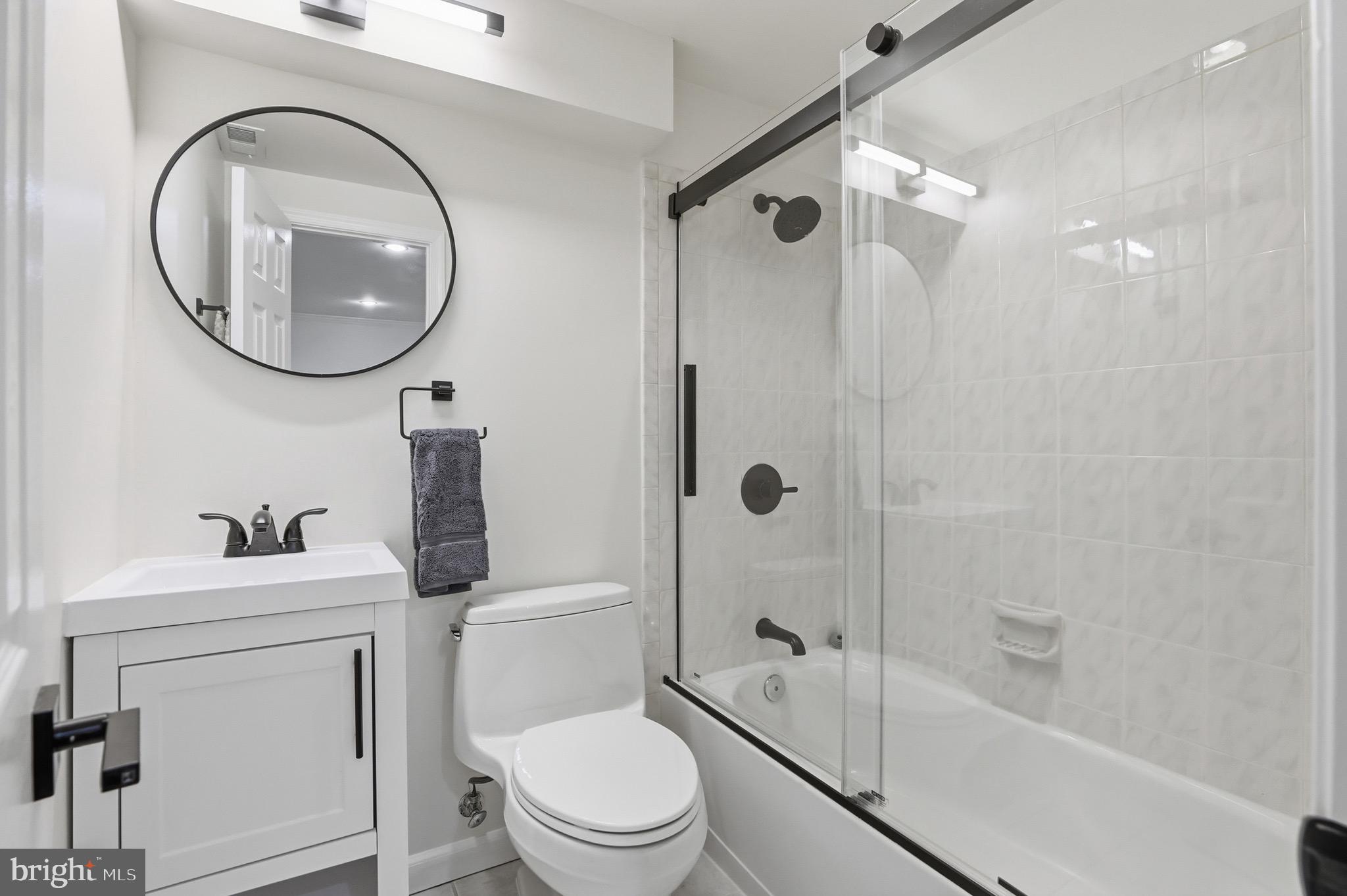 13222 Maplecrest Drive Potomac, MD 20854 - Photo 42 of 61 a bathroom with a toilet a sink and a mirror
