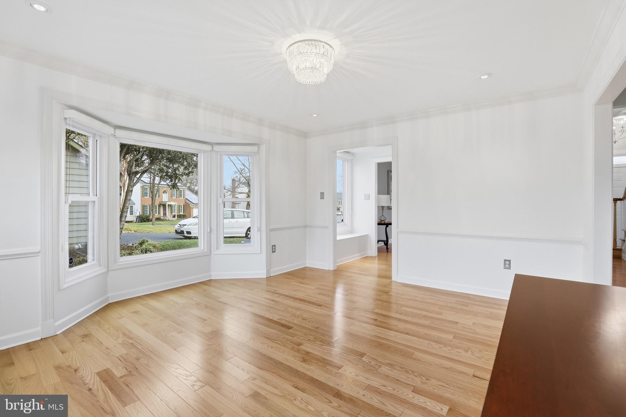 13222 Maplecrest Drive Potomac, MD 20854 - Photo 10 of 61 a view of an empty room with wooden floor and a window