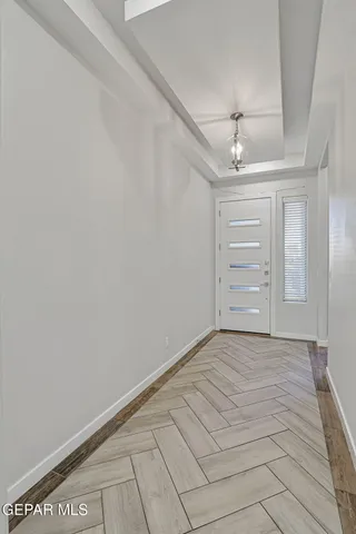 a large kitchen with stainless steel appliances kitchen island a large counter top and wooden floors