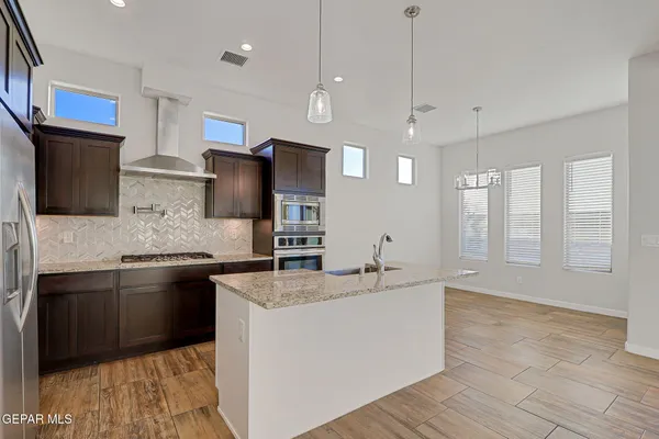 a kitchen with granite countertop a sink and a counter top space