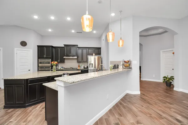 a large kitchen with stainless steel appliances and a kitchen island