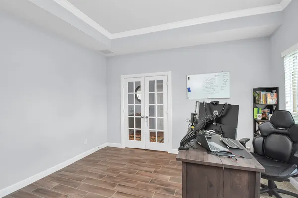 a view of workspace with wooden floor windows gym equipment and windows