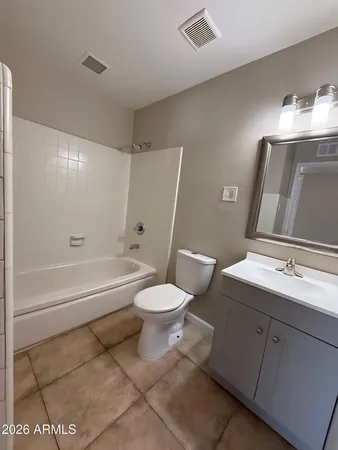 a bathroom with a toilet sink vanity tub and shower