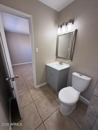 a white toilet sitting next to a bathroom sink