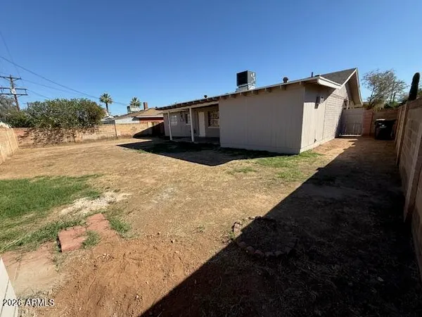 a backyard of a house with wooden fence