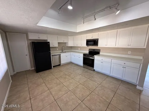 a kitchen with a sink a stove and cabinets