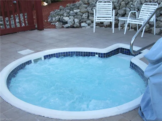 a view of a swimming pool with a lounge chair