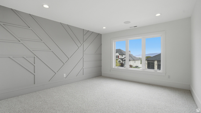 1682 North 1950 W Street, Unit 9 Provo, UT 84604 - Photo 62 of 84 Room featuring a textured accent wall with geometric molding, recessed lighting, and light-colored carpeting