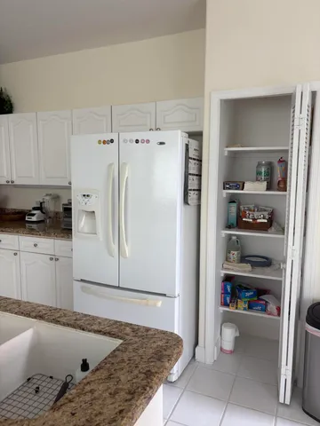 a kitchen with granite countertop a sink and cabinets