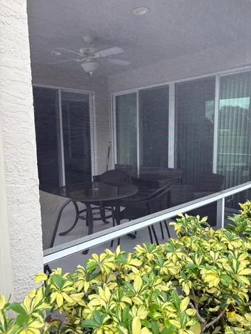 a view of a room with furniture and a window