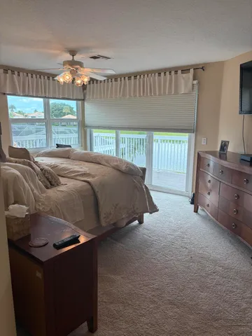 a bedroom with bed and window