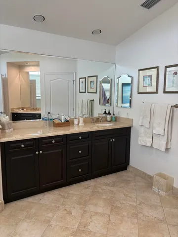 a view of bathroom with a sink and a mirror