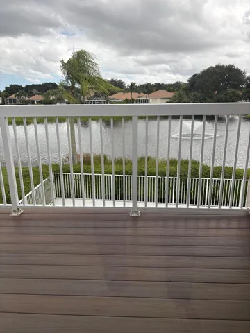a view of balcony with mountain view and wooden floor