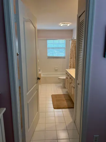 a bathroom with a double vanity sink mirror and toilet