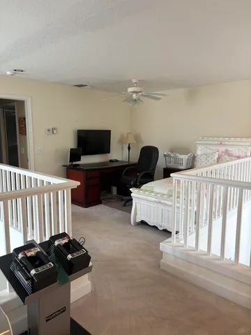 a bedroom with a bed window and a chair