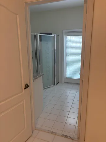 a bathroom with a granite countertop toilet sink and mirror