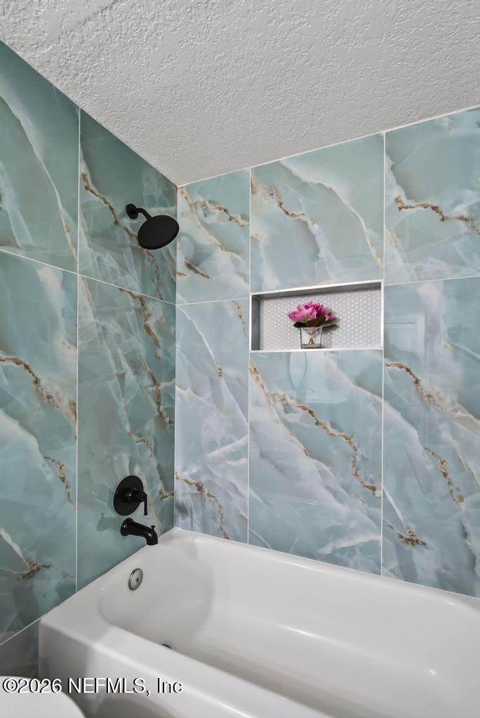 43739 Ratliff Road Callahan, FL 32011 - Photo 38 of 55 a bathroom with a bathtub and shower