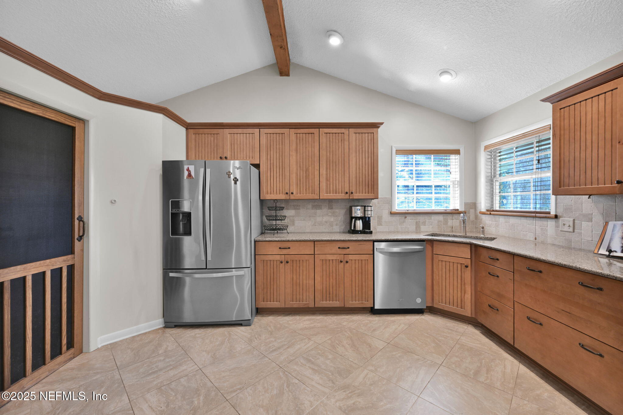 3541 Pacetti Road St. Augustine, FL 32092 - Photo 37 of 74 a kitchen with granite countertop a refrigerator and a sink