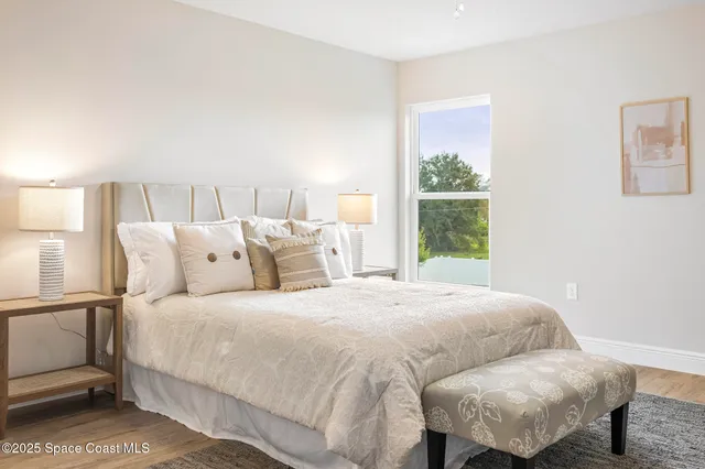 a bedroom with a bed and window