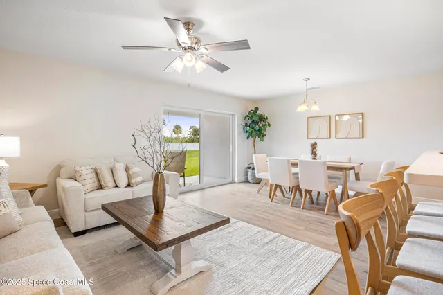 a living room with furniture a rug and a chandelier