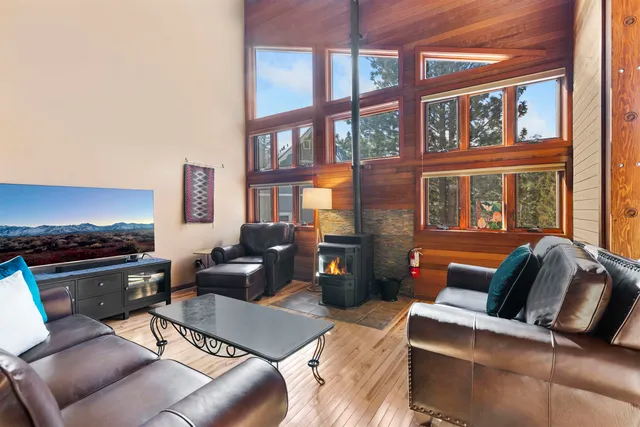 a living room with furniture fireplace and a window