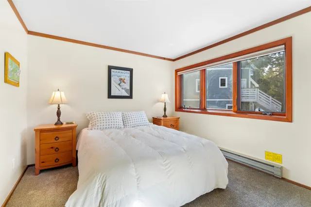 a bedroom with a large bed and a large window