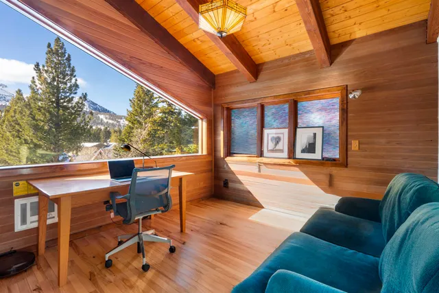 a view of a patio with couches chairs and wooden floor