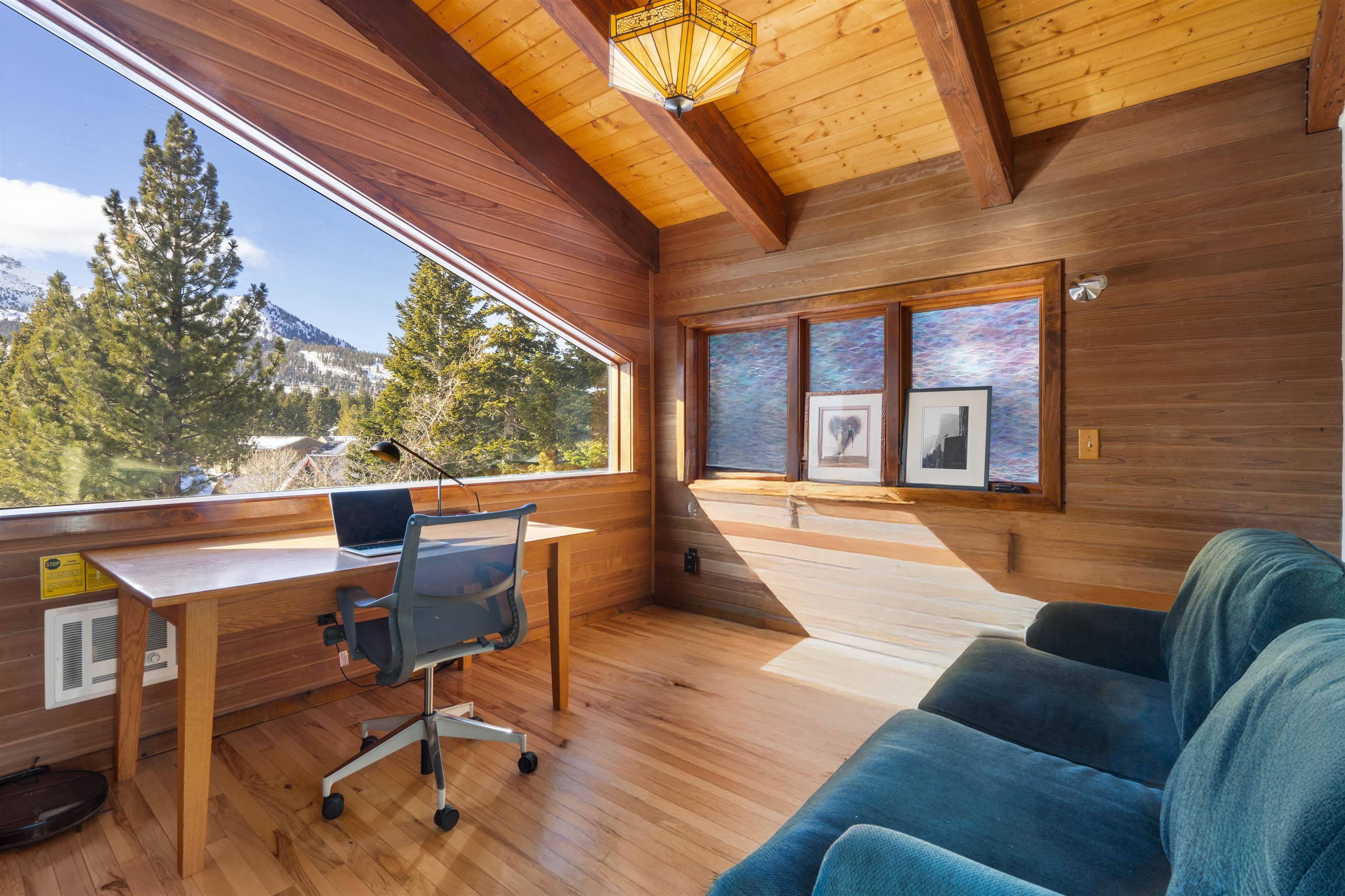 36 Ski Trails Road, Unit 8 Mammoth Lakes, CA 93546 - Photo 5 of 29 a view of a patio with couches chairs and wooden floor