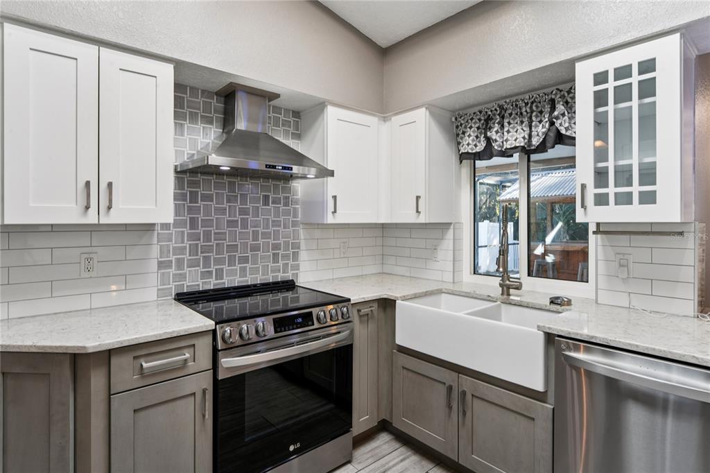 8357 Matthew Drive New Port Richey, FL 34653 - Photo 14 of 78 a kitchen with a sink stove and cabinets