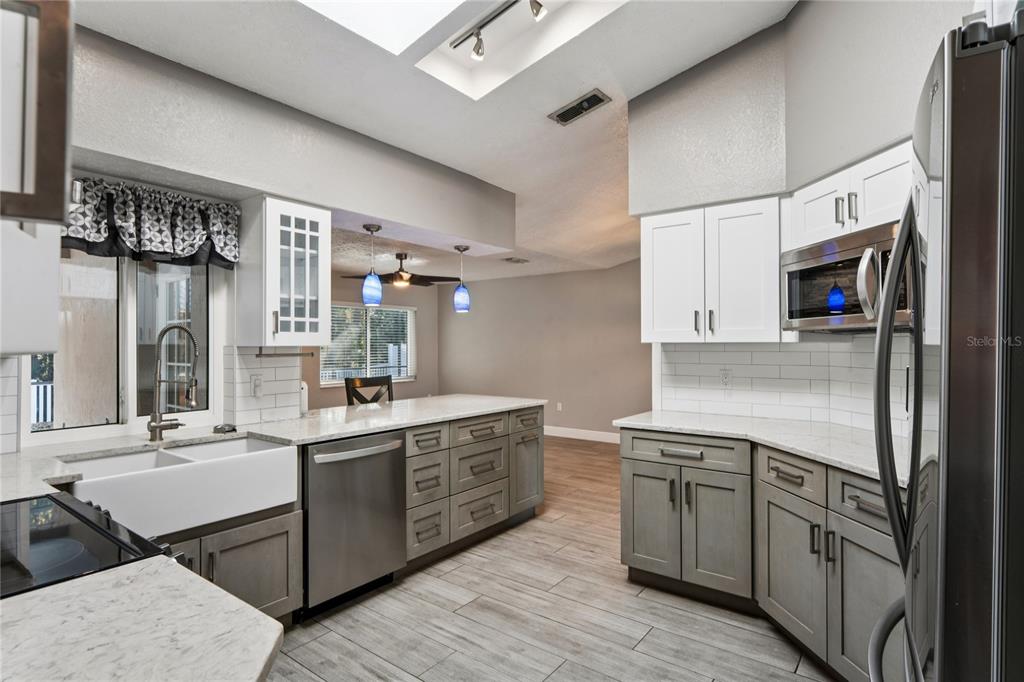 8357 Matthew Drive New Port Richey, FL 34653 - Photo 16 of 78 a kitchen with a sink appliances cabinets and furniture