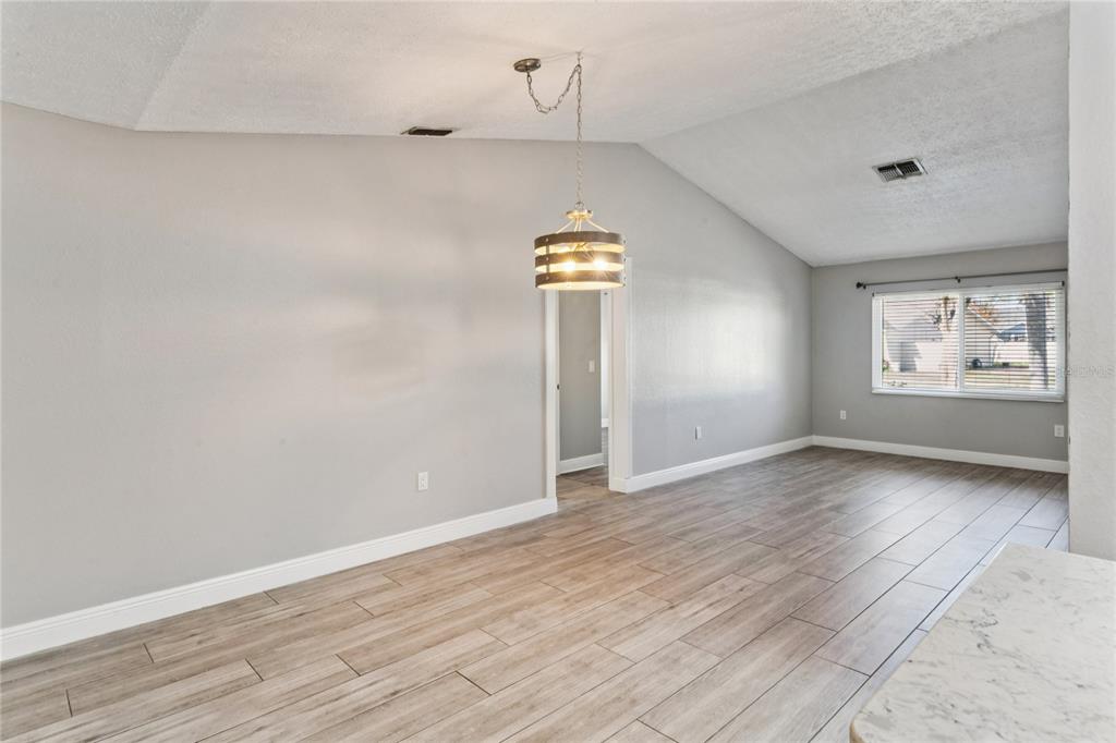8357 Matthew Drive New Port Richey, FL 34653 - Photo 21 of 78 wooden floor in an empty room with a window