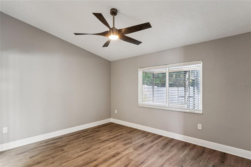 8357 Matthew Drive New Port Richey, FL 34653 - Photo 31 of 78 a view of an empty room with wooden floor and a window