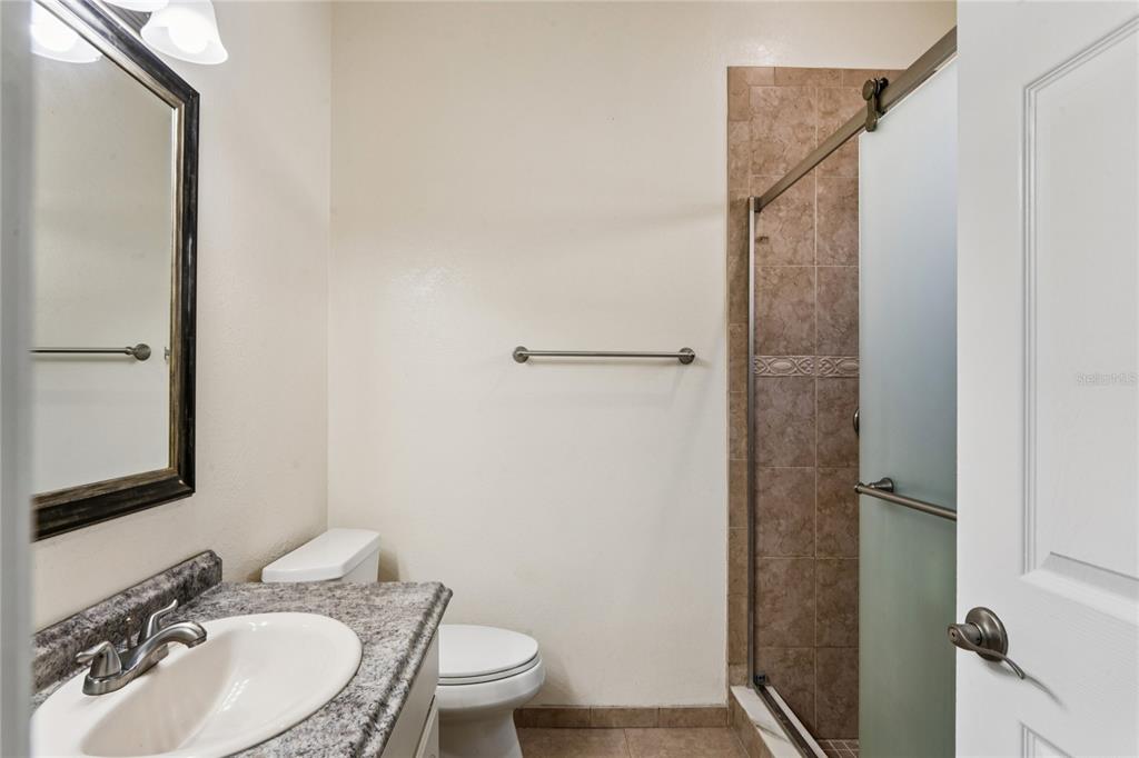 8357 Matthew Drive New Port Richey, FL 34653 - Photo 33 of 78 a bathroom with a sink toilet and shower