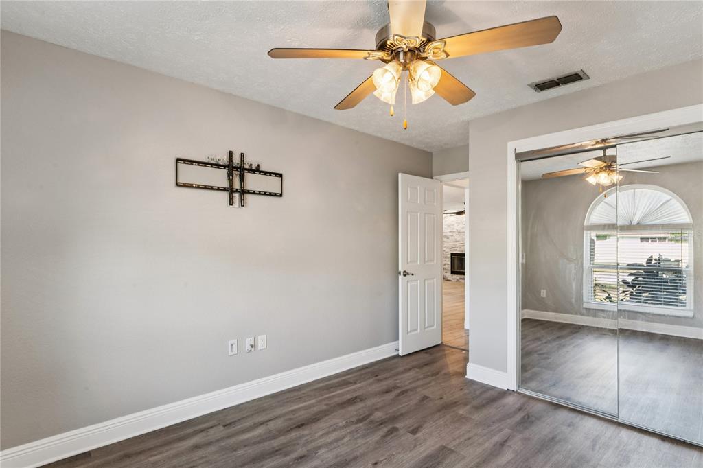 8357 Matthew Drive New Port Richey, FL 34653 - Photo 37 of 78 wooden floor in an empty room with a window