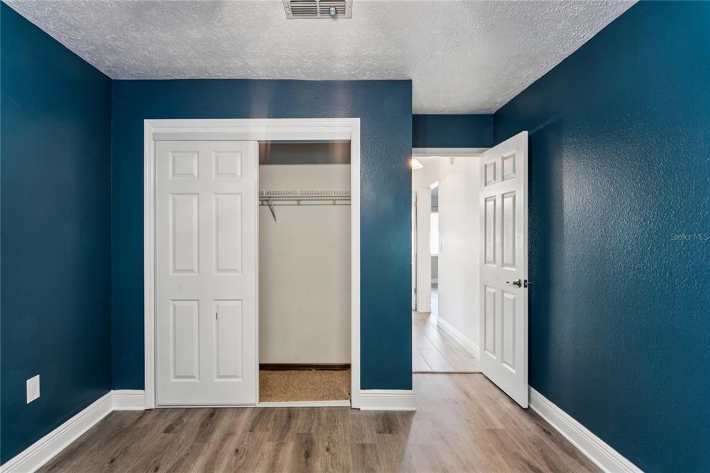 8357 Matthew Drive New Port Richey, FL 34653 - Photo 44 of 78 an empty room with wooden floor and closet