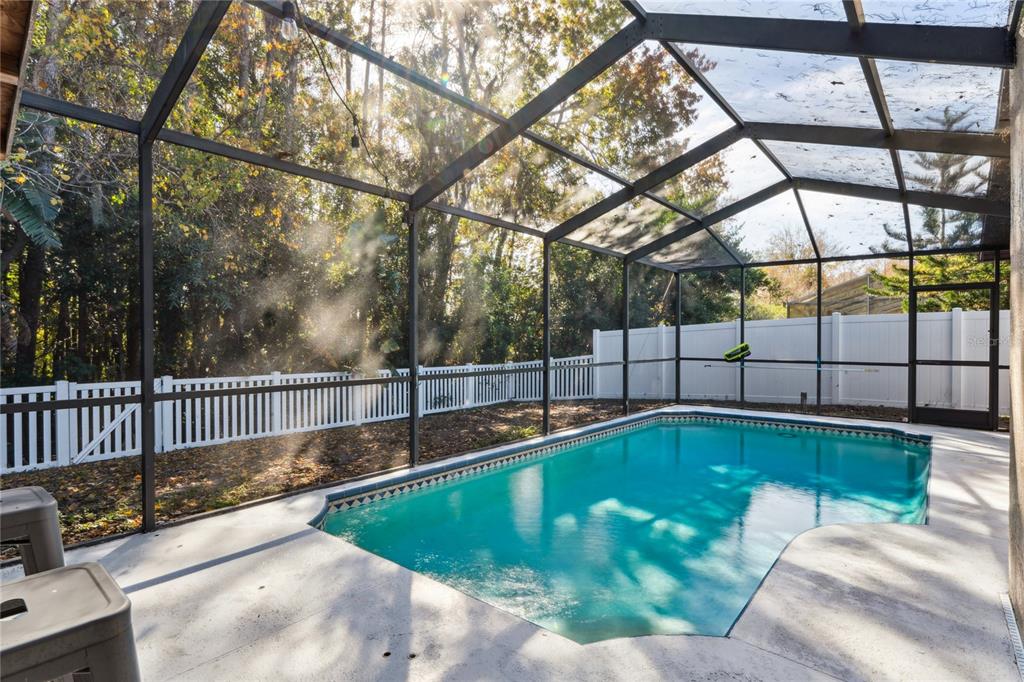 8357 Matthew Drive New Port Richey, FL 34653 - Photo 51 of 78 a view of a backyard with a swimming pool