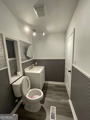 a bathroom with a toilet and a sink