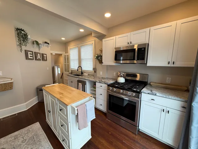 a kitchen with stainless steel appliances granite countertop a stove and a sink