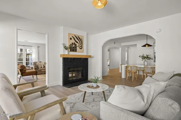 a living room with furniture a fireplace and a table