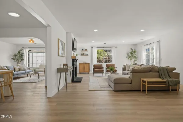 a living room with furniture and wooden floor
