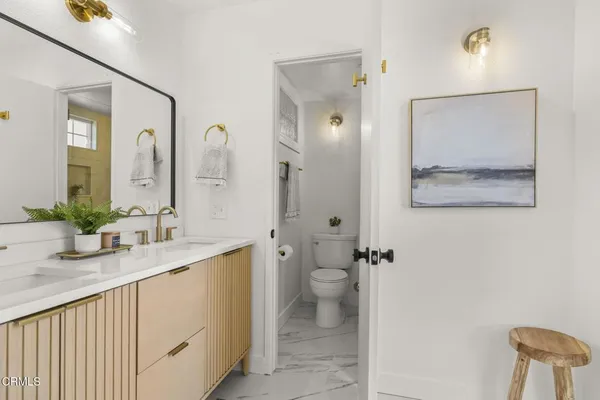 a bathroom with a sink a vanity and a mirror